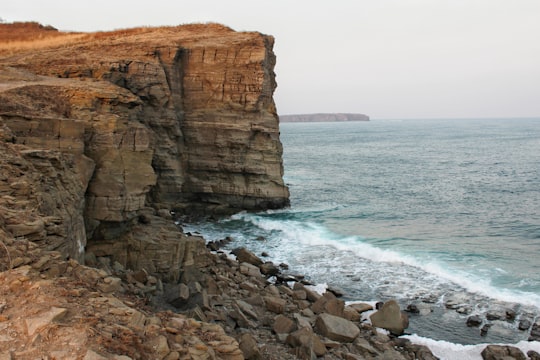 rocky mountain on seashore during daytime in Vladimir Russia