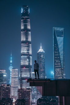 man standing on top of skyscraper