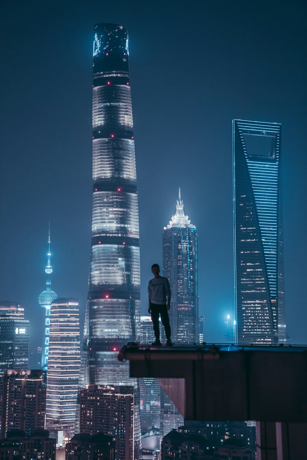 man standing on top of skyscraper