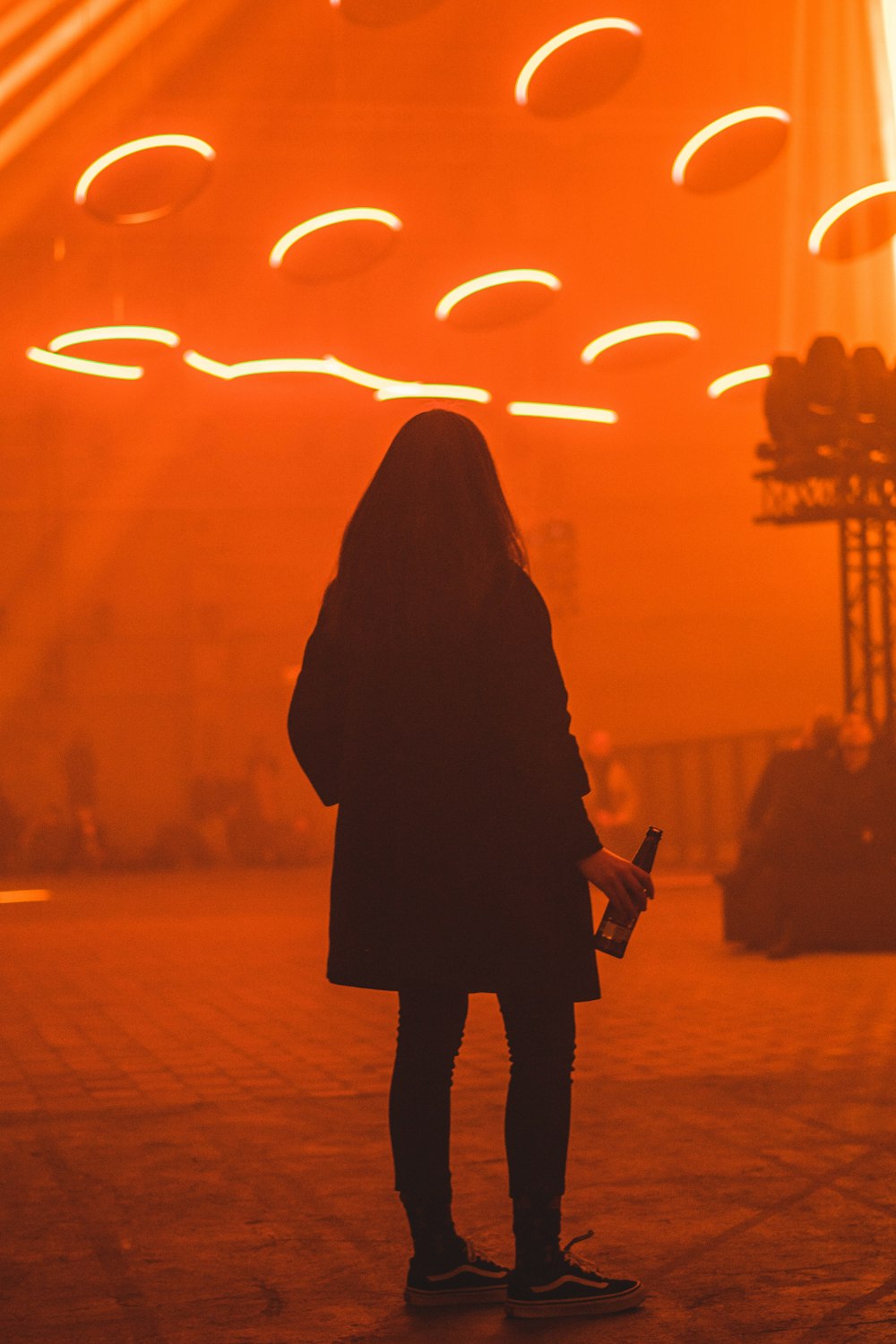 woman holding bottle inside lightning room