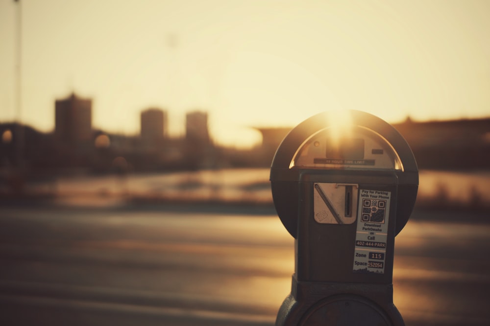 shallow depth of field photo of gray coin-operated parking meter
