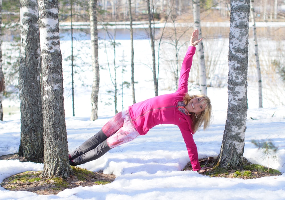 woman doing exercise outdoor in beside trees