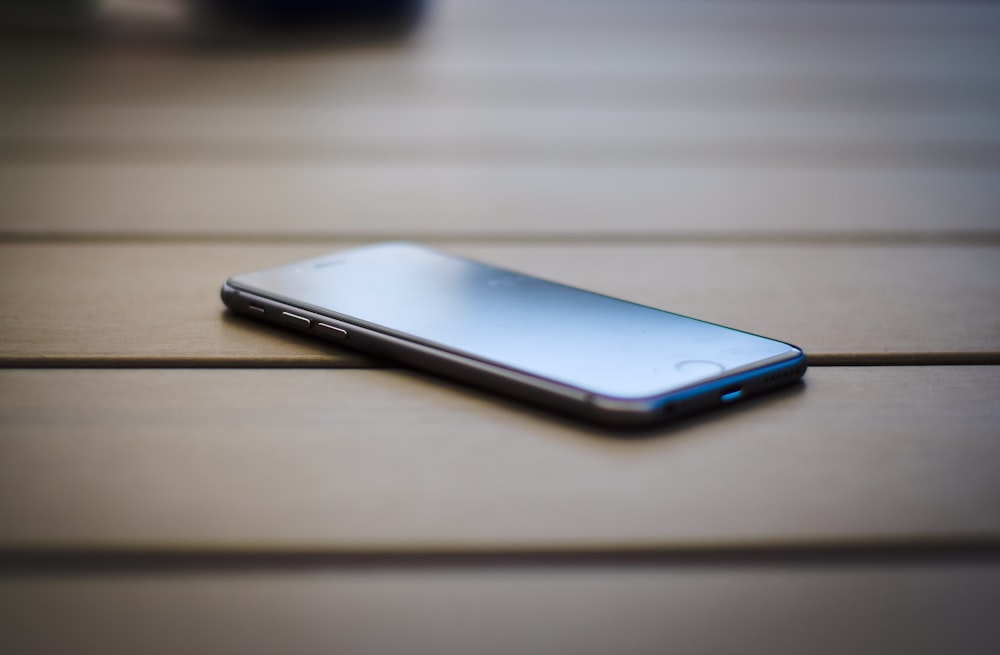 black iPhone 7 on brown table