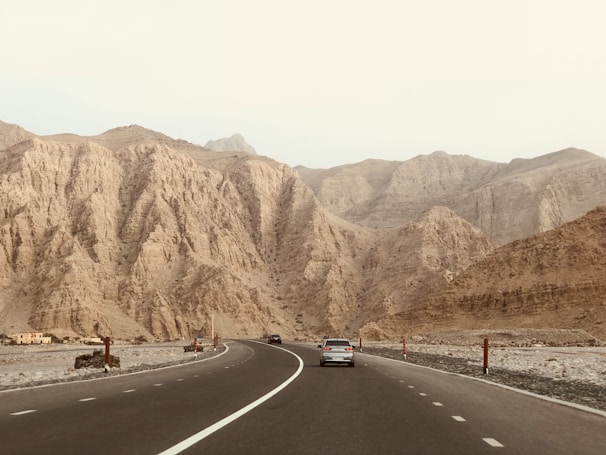 two vehicles on concrete highways near on mountains