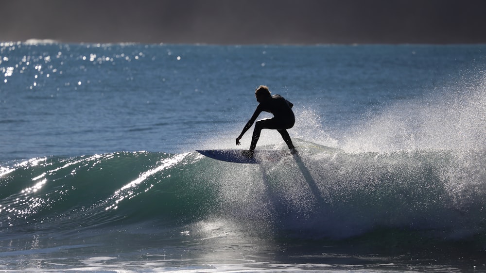 person riding surfboard on water barrel