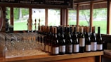 A charming tasting room with bottles of wine and glasses ready for a tasting session.