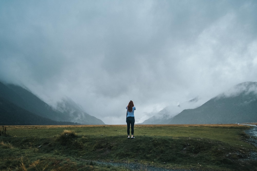 woman standing on green grass field