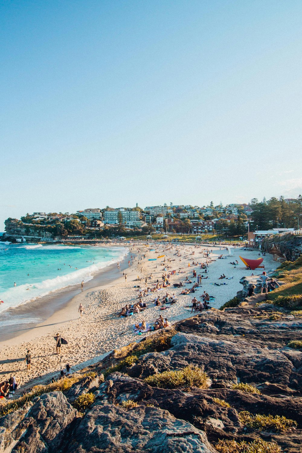 people near beach under clear blue sky