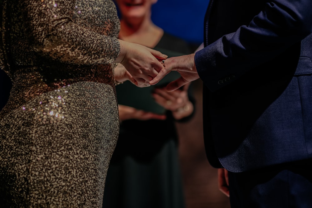 a couple holding hands during a wedding ceremony