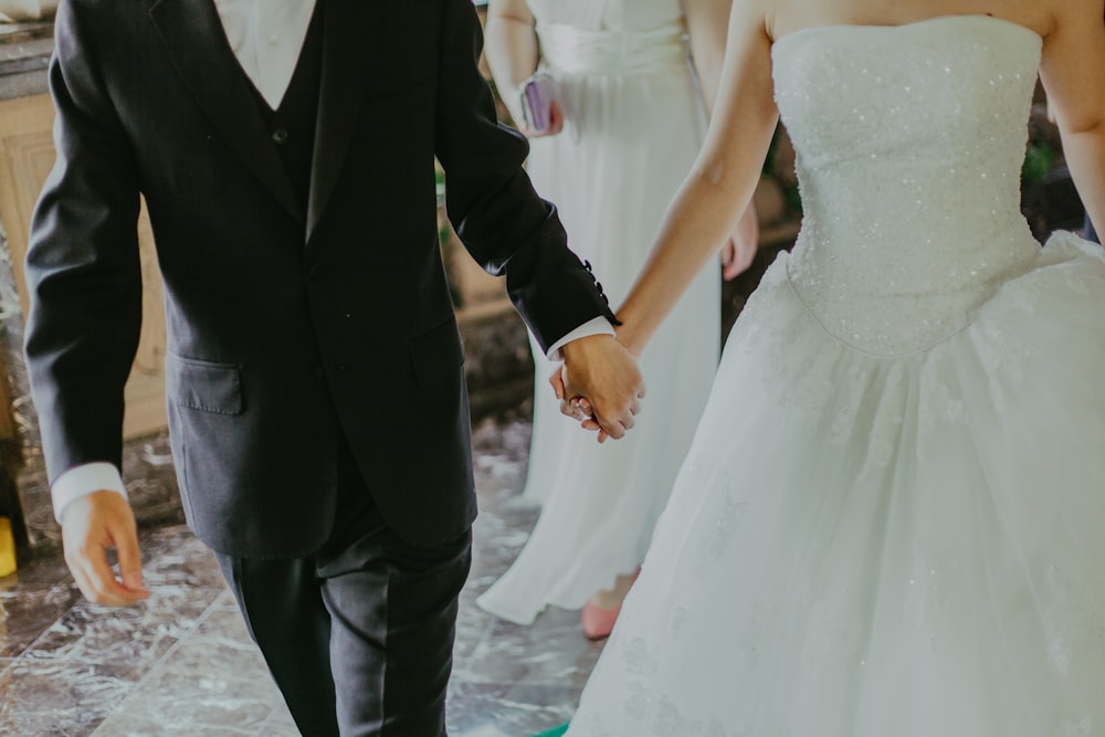 groom and bridge holding hands