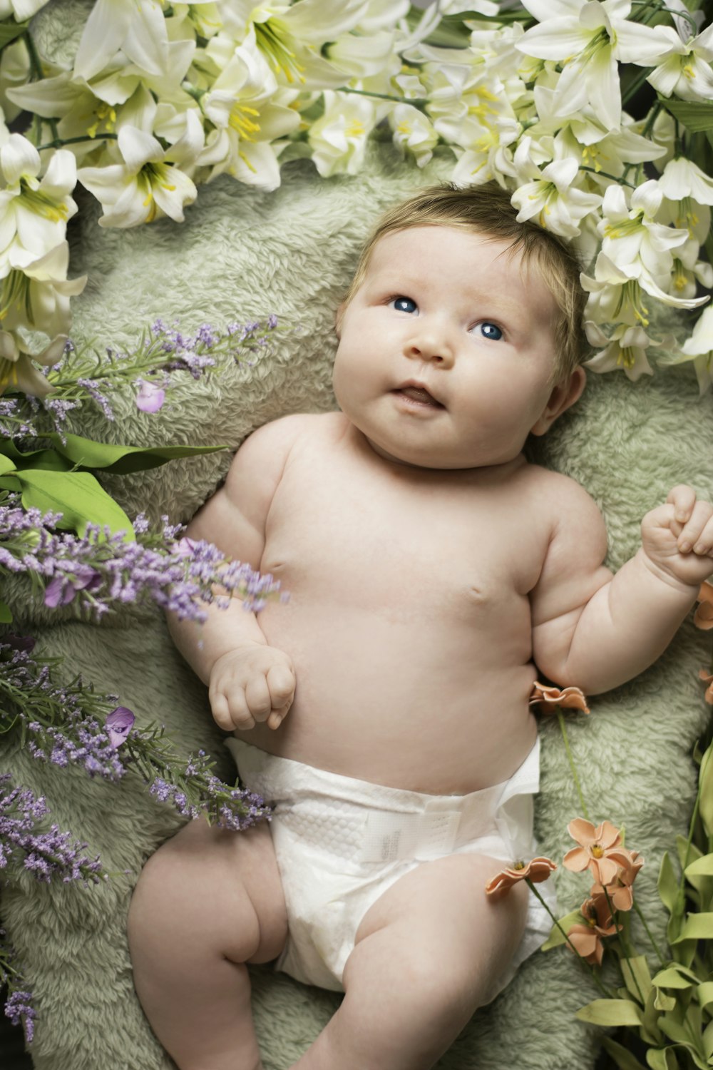 baby on green sleeper with flowers