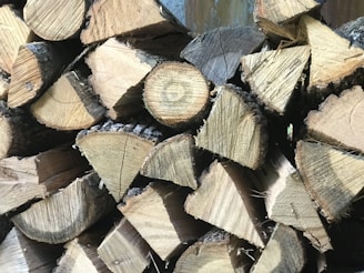 A stack of freshly cut wooden planks ready for shipment at a lumber yard.