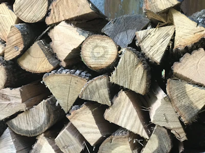 Close-up of freshly cut wooden logs stacked neatly for processing.