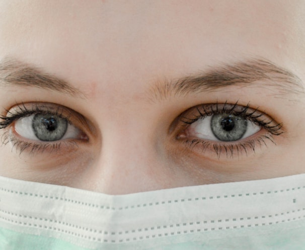 closeup photo of woman's eye wearing mask