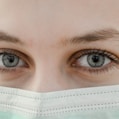 closeup photo of woman's eye wearing mask