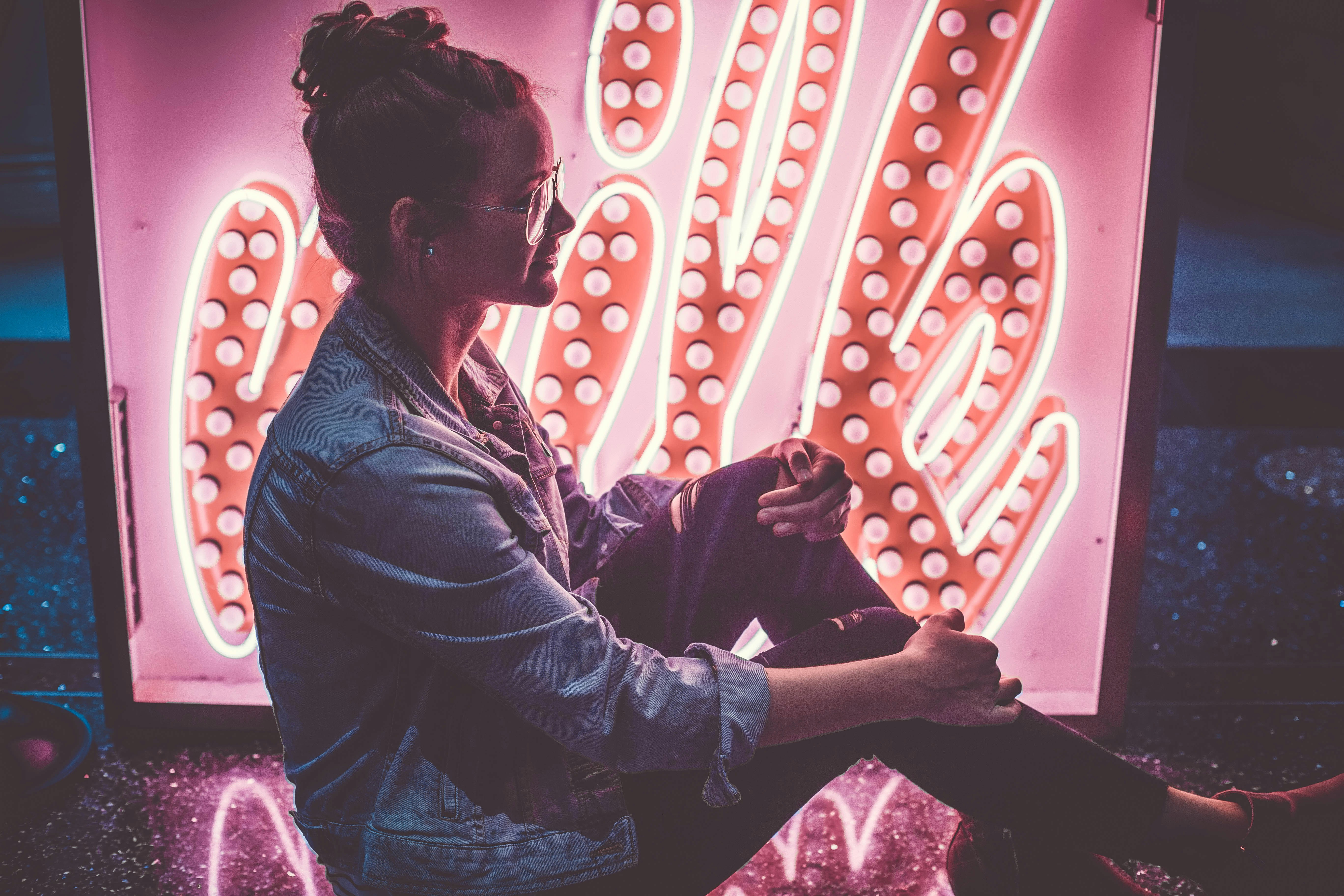 woman sitting on floor while holding her knee