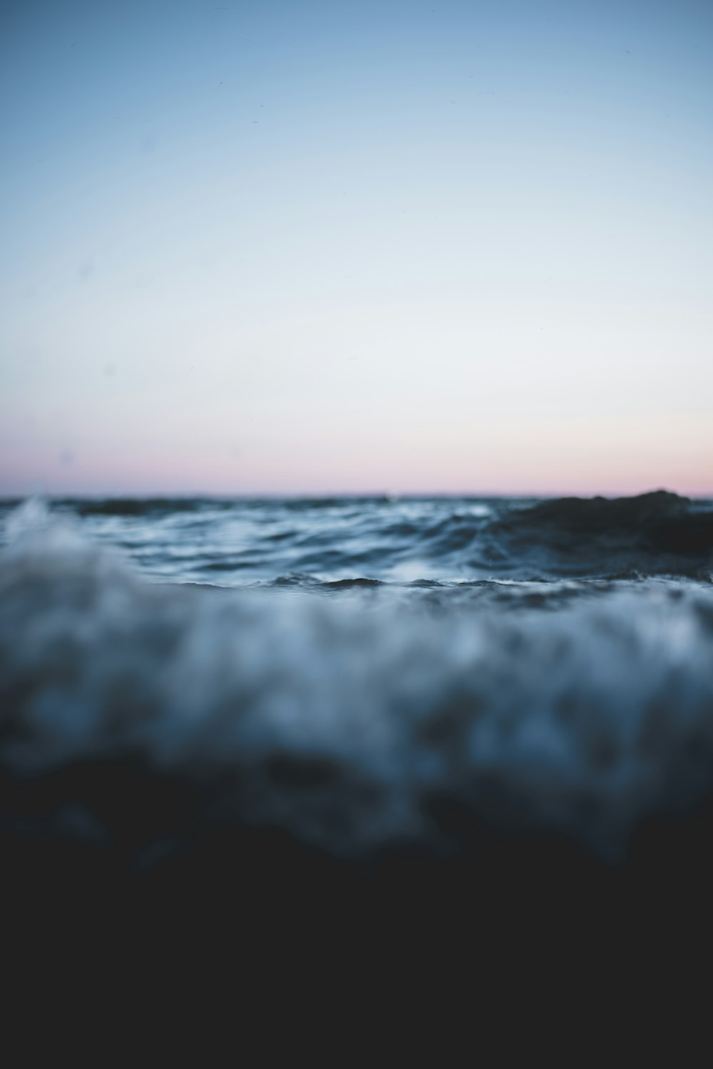 body of water under blue and white sky