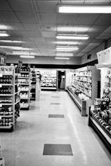 Moving image of a clean, organized supermarket aisle with customers shopping.