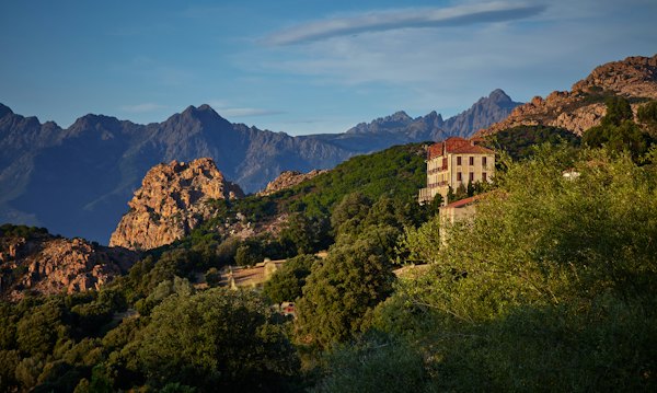 Green and brown concrete house on mountain — Corsica, France