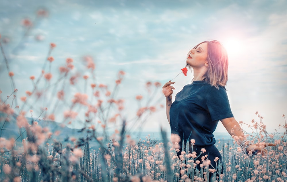 woman holding red flower