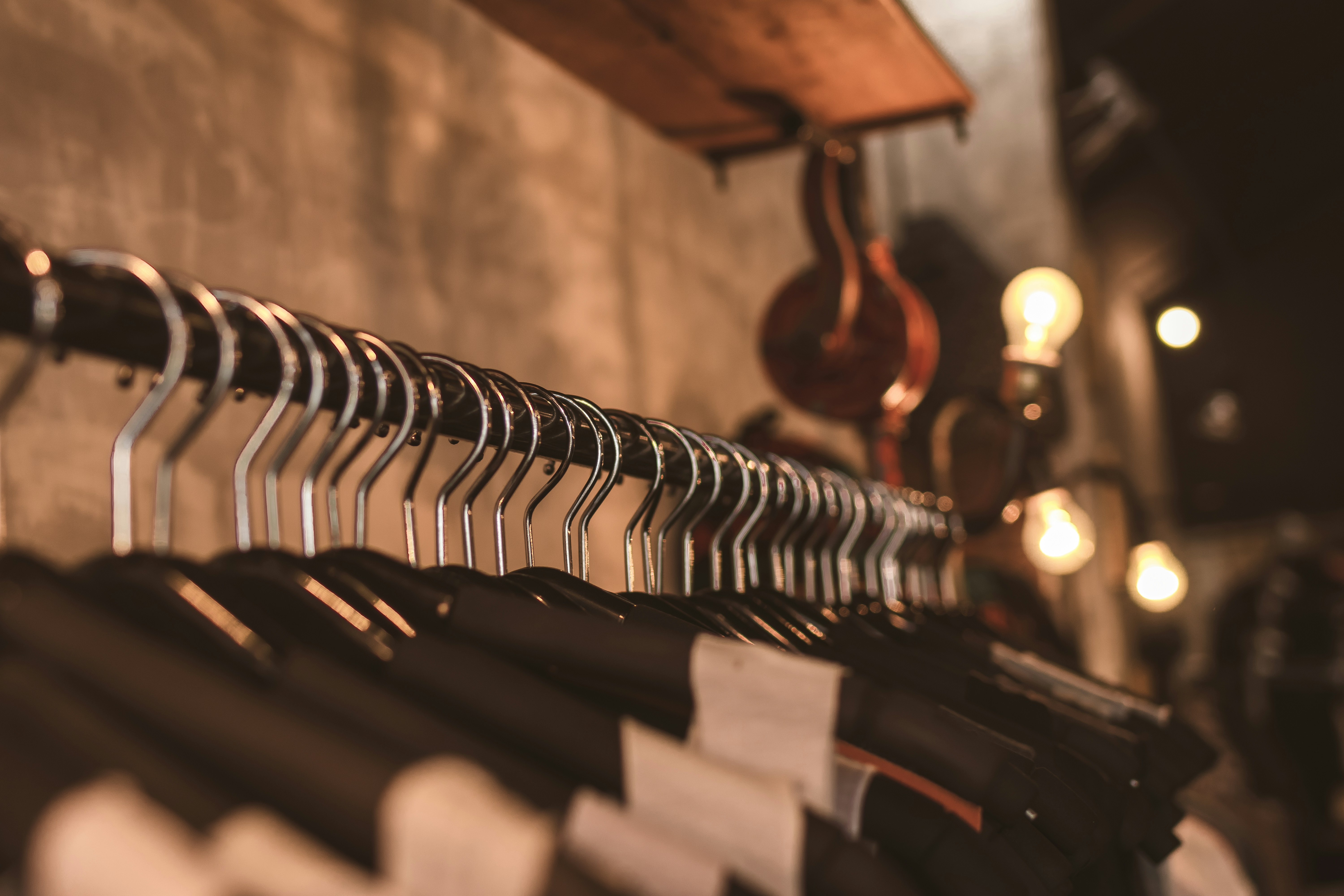 Dark navy fleece jacket hanging on rack, clean studio background, crisp lighting