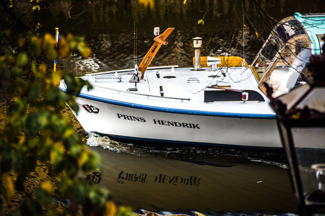 white and blue Prins Hendrik fishing boat on water