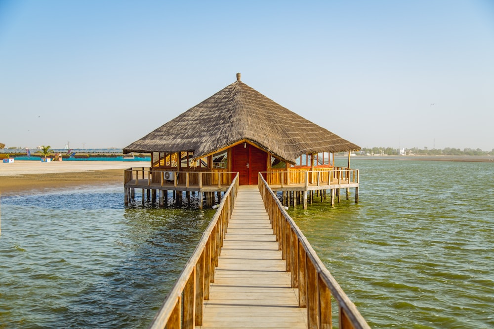 brown wooden shed surrounded body of water