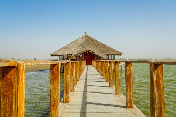 A jetty out to a thatched hut — Sine-Saloum Delta, Senegal