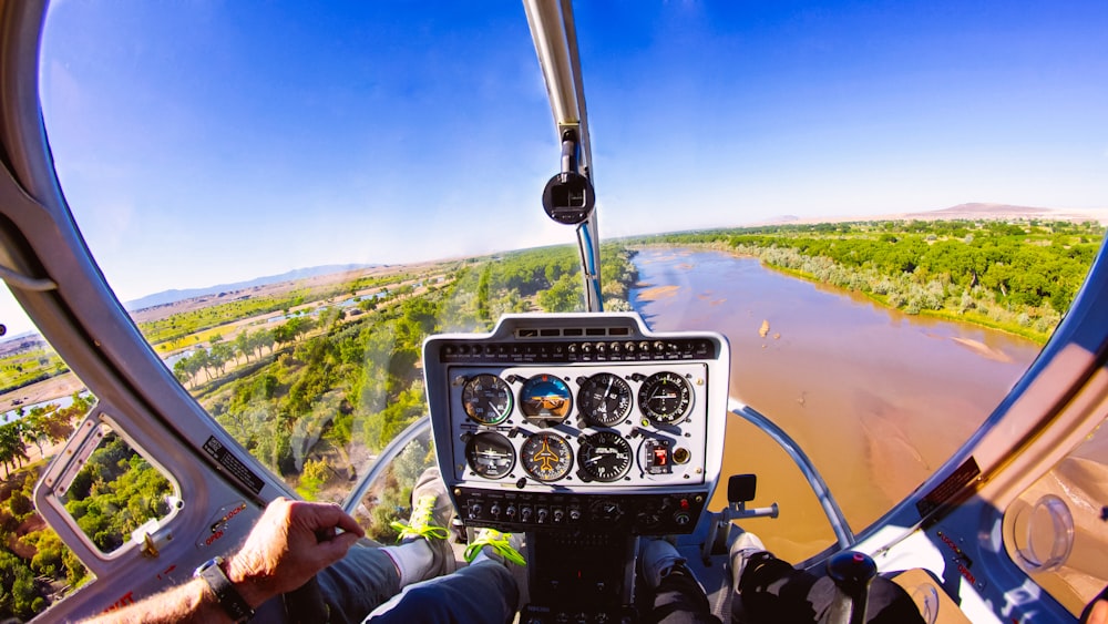 person inside aircraft flight above river