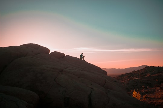 person sitting on rock in Joshua Tree United States