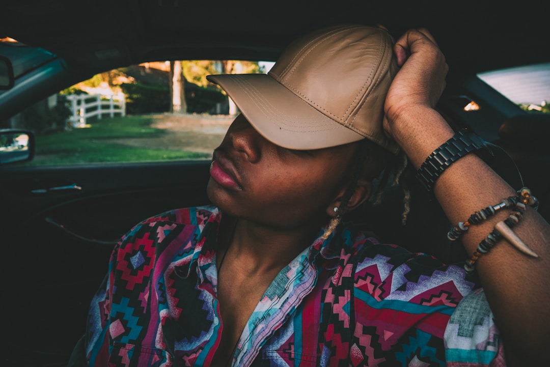 man wearing brown hat on car