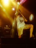 man holding microphone while up on stage
