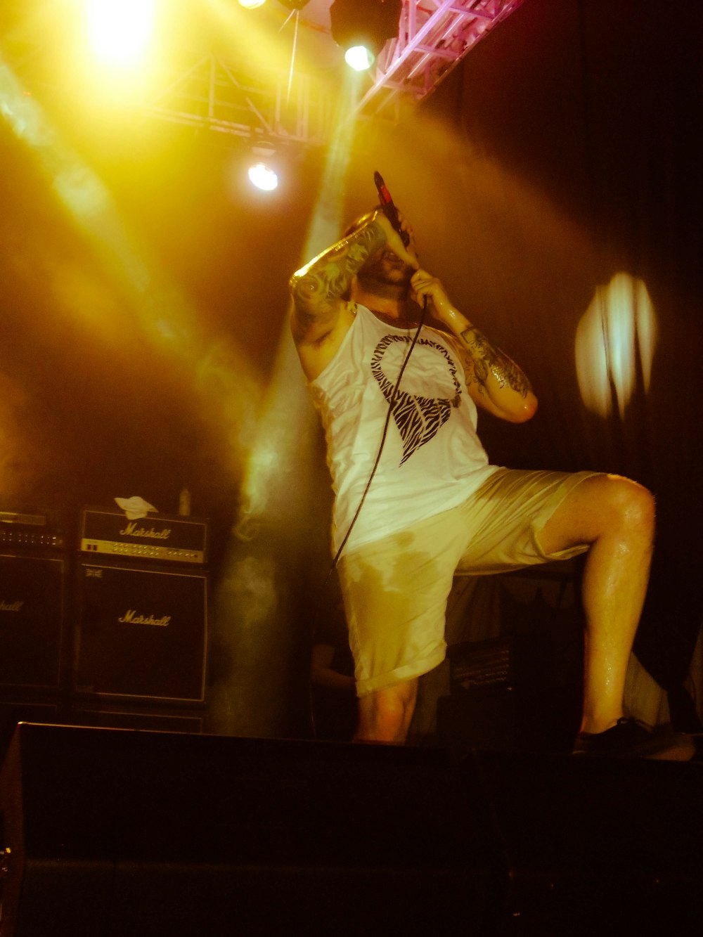 man holding microphone while up on stage