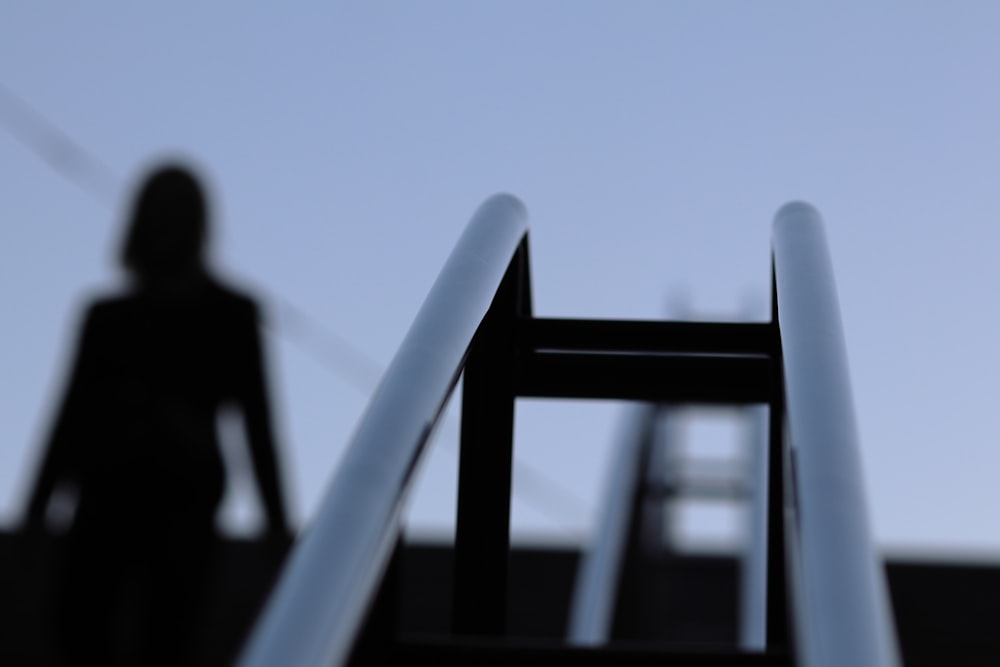 a person standing next to a metal chair