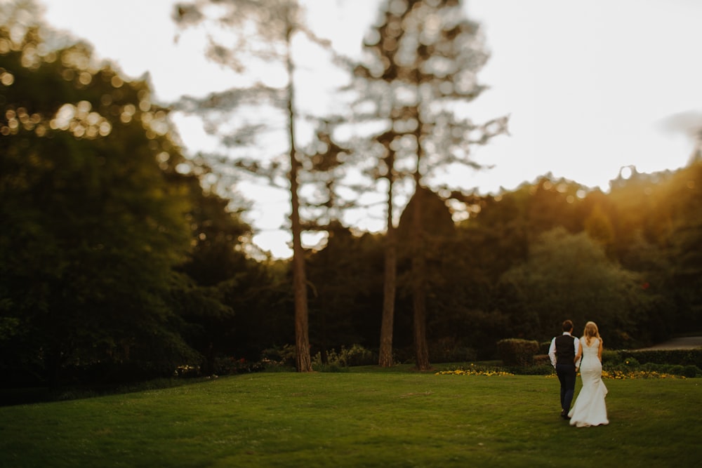 couple walking near tree during daytime