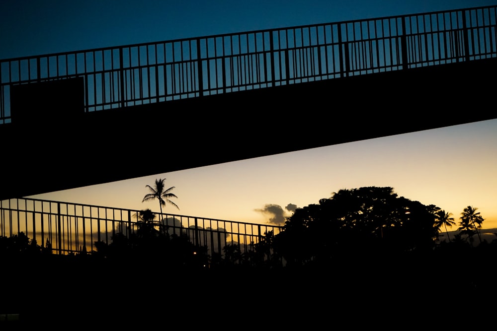 silhouette of bridge during golden hour