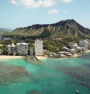 aerial photo of gray high rise buildings and mountain at daytime