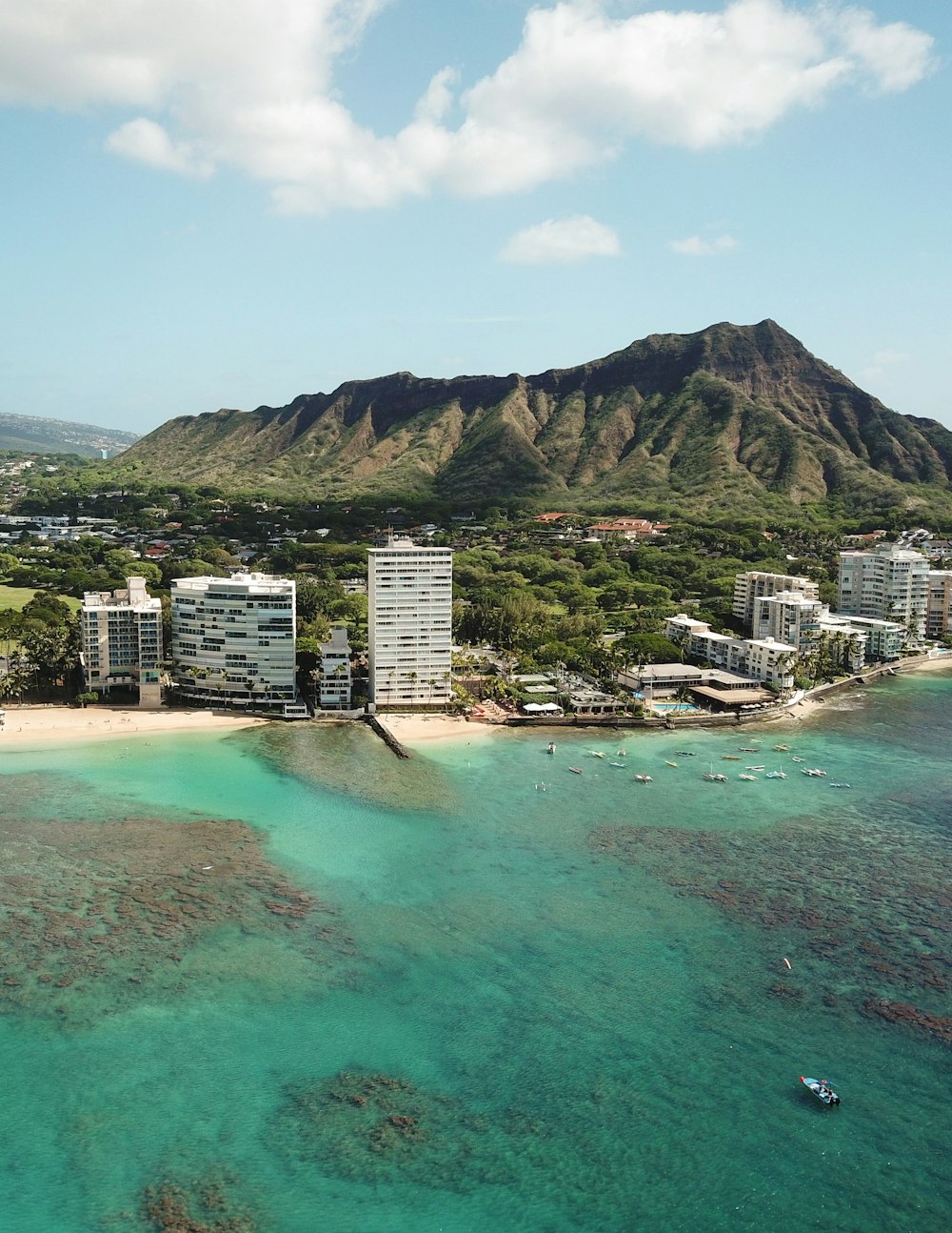 aerial photo of gray high rise buildings and mountain at daytime