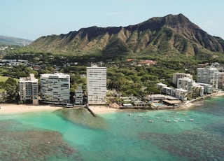 aerial photo of gray high rise buildings and mountain at daytime