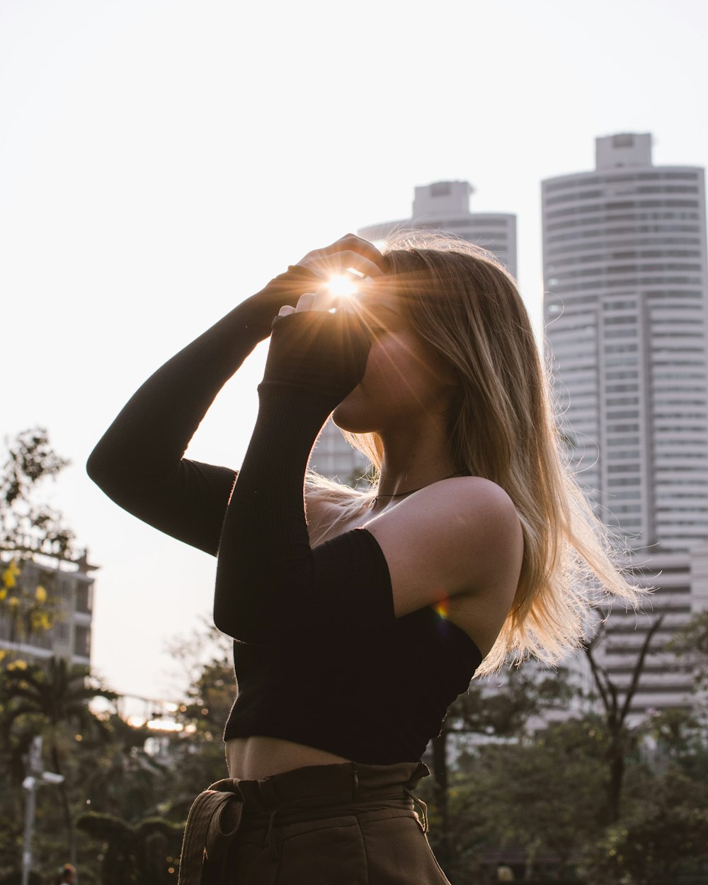 selective focus photography of woman wearing black crop-top, long sleeves and brown bottoms