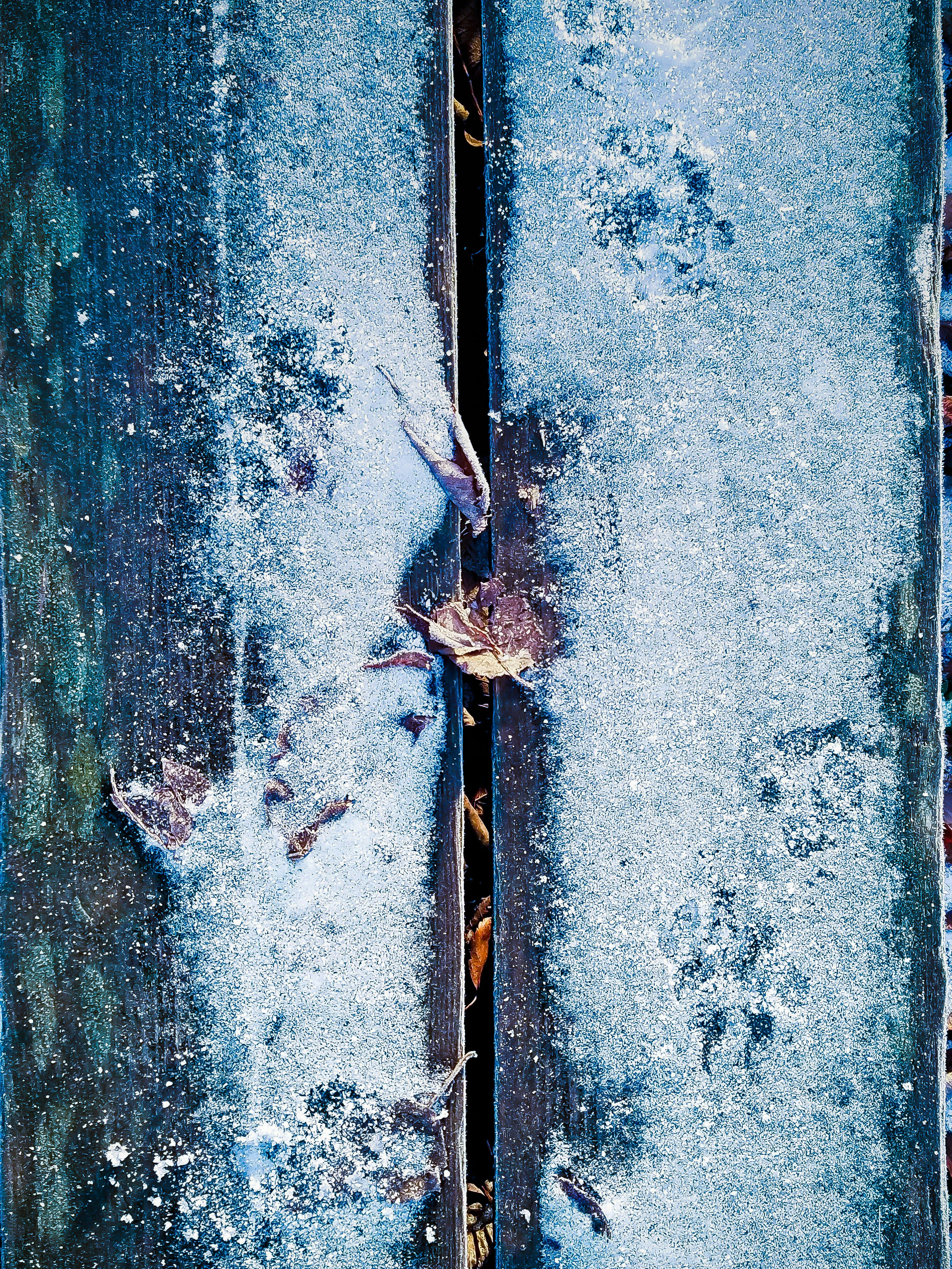 green wooden plank board covered of snow
