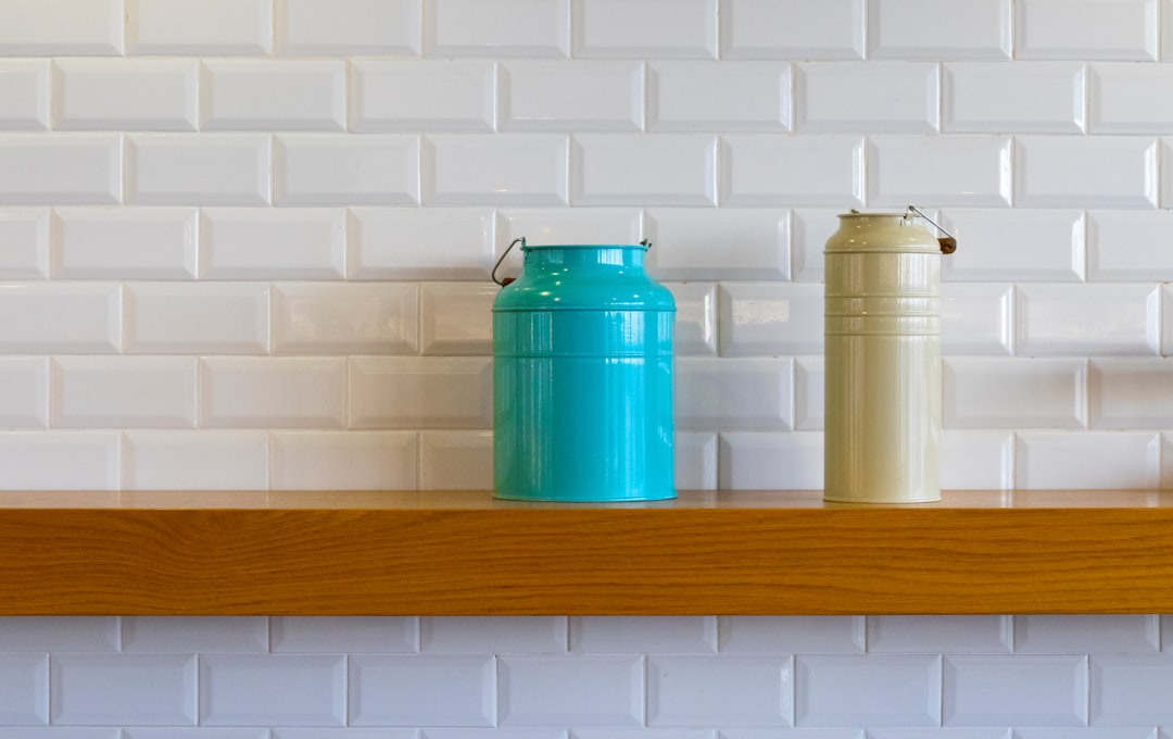  two teal and brown metal cans on shelf pot container utensils