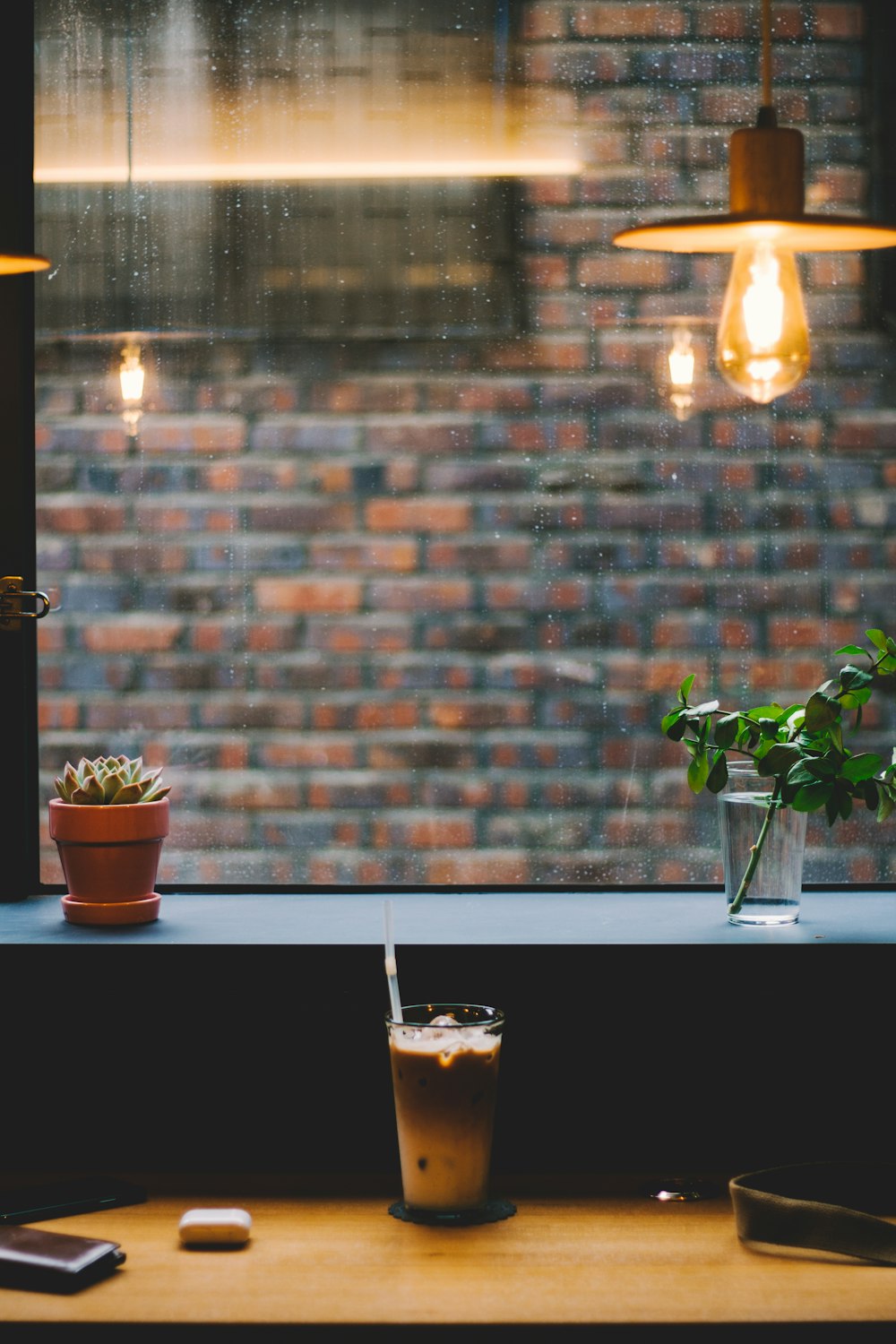 clear drinking glass beside wall