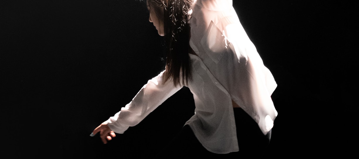 woman in white dress shirt dancing on stage