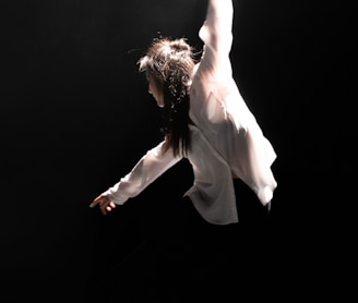 woman in white dress shirt dancing on stage