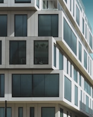 a tall white building with lots of windows