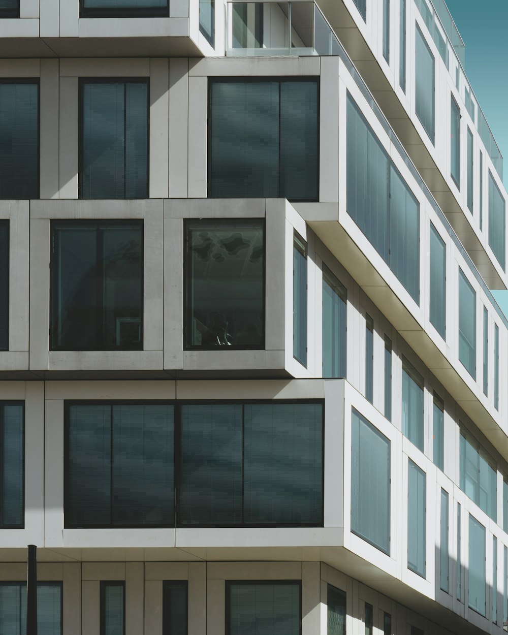 a tall white building with lots of windows