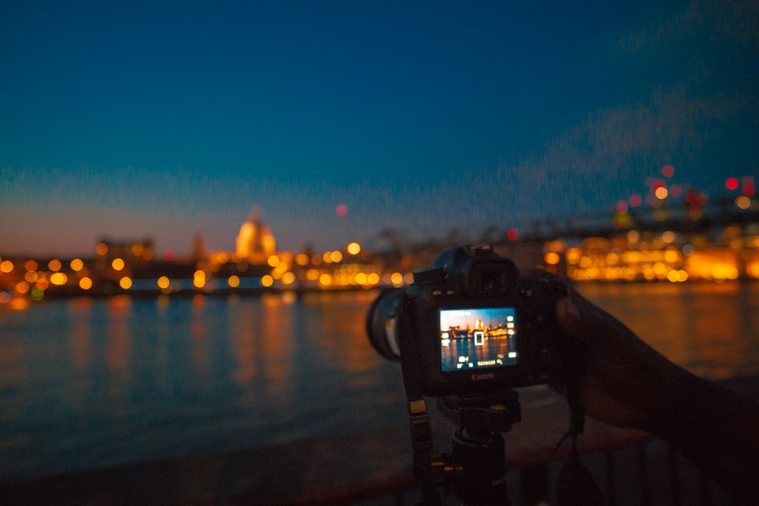 camera capturing lighted cityscape