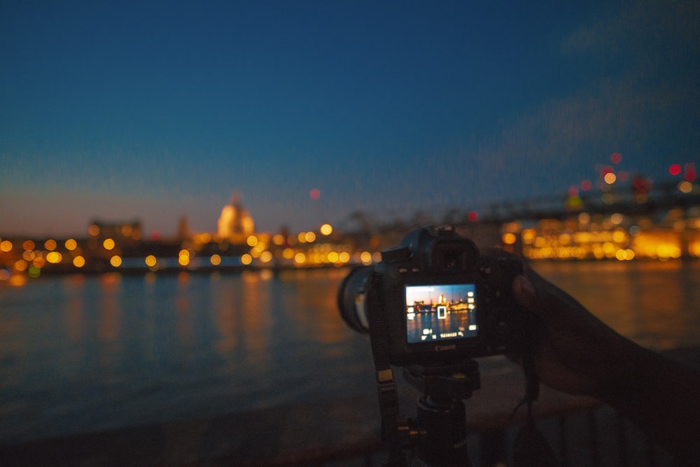 camera capturing lighted cityscape