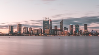 Urban skyline of Parramatta at dusk with soft city lights glowing under a calm sky.